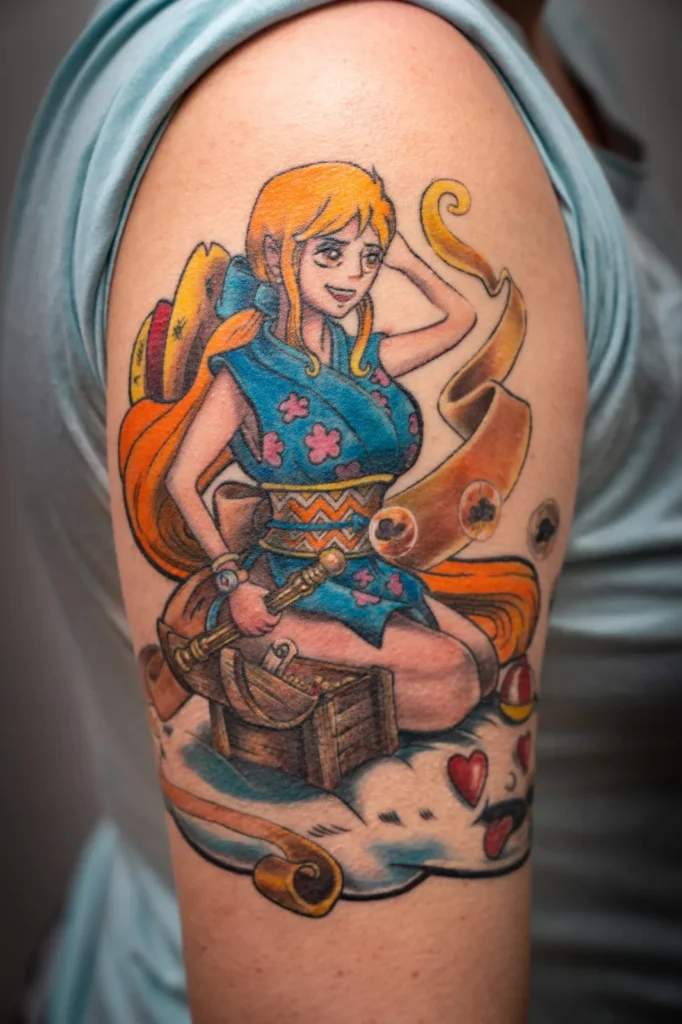 Tatuaje a color de un personaje de anime con kimono azul sentado sobre un cofre del tesoro, en el brazo